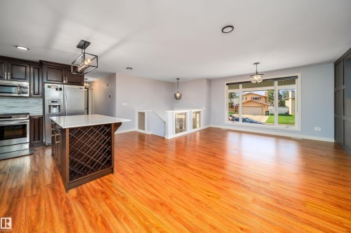 Open-concept kitchen and living area featuring wood-finish flooring - 126 Harrison Drive, Edmonton, AB - Indoor Photo Showing Other Room