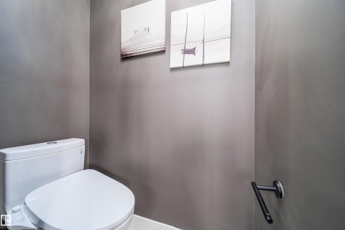Contemporary toilet fixture with a grey wall finish and matte black hardware - 126 Harrison Drive, Edmonton, AB - Indoor Photo Showing Bathroom