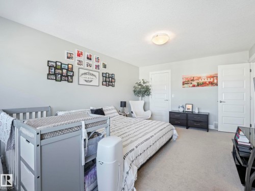 Neutral-toned interior room featuring light gray walls, white trim, and light-colored carpeting - 3817 Robins Crescent, Edmonton, AB - Indoor Photo Showing Bedroom