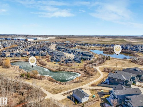 Aerial perspective showcasing a residential community with multiple homes and natural water features - 3817 Robins Crescent, Edmonton, AB - Outdoor With View