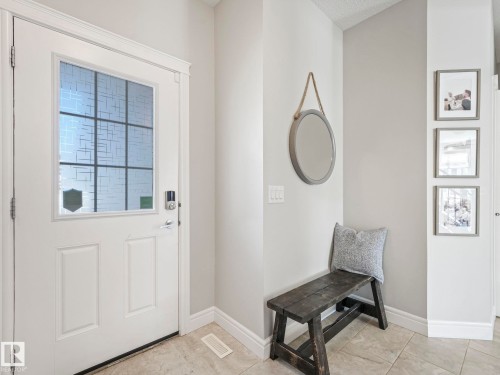 Entryway featuring a white paneled door with a decorative glass insert and contemporary hardware - 3817 Robins Crescent, Edmonton, AB - Indoor Photo Showing Other Room