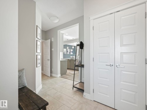 Entryway featuring large format tile flooring, white six-panel doors, white trim, and light gray walls - 3817 Robins Crescent, Edmonton, AB - Indoor Photo Showing Other Room