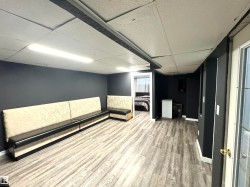 Interior space featuring a drop ceiling and light wood-type flooring - 