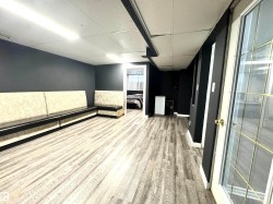 Unfurnished room featuring light wood-type flooring and a drop ceiling - 