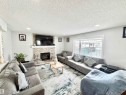 Living area featuring a stone fireplace, a textured ceiling, and recessed lighting - 6734 162A Avenue, Edmonton, AB  - Indoor Photo Showing Living Room With Fireplace 