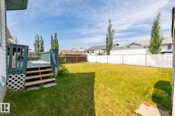 Fenced backyard featuring a deck and a residential view - 