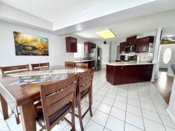 Dining area featuring a textured ceiling and light tile patterned flooring - 