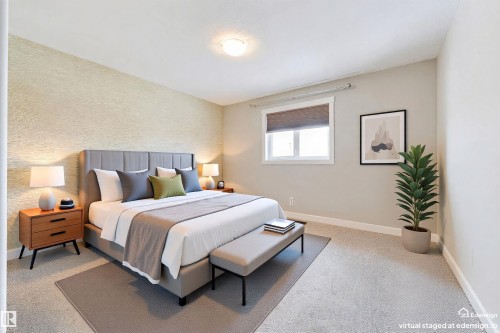 Textured accent wall and neutral paint tones complement the wall-to-wall carpeting - 4914 47 Street, Redwater, AB - Indoor Photo Showing Bedroom