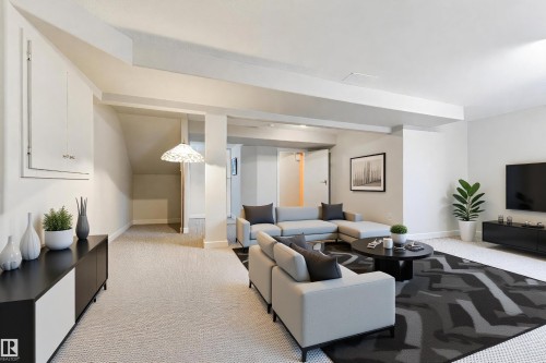 Spacious lower-level area with light-toned carpeting throughout - 4914 47 Street, Redwater, AB - Indoor Photo Showing Living Room