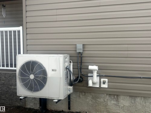 Exterior wall featuring horizontal siding and a mounted HVAC unit - 4914 47 Street, Redwater, AB - Outdoor With Exterior