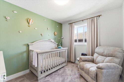 Carpeted room featuring a single window with curtain rod and drapes, and a ceiling-mounted light fixture - 54 Cypress Link, Fort Saskatchewan, AB - Indoor Photo Showing Bedroom