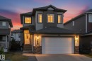 Contemporary two-story residence featuring a two-car garage, stone veneer accents, and a covered front entry - 54 Cypress Link, Fort Saskatchewan, AB  - Outdoor With Facade 