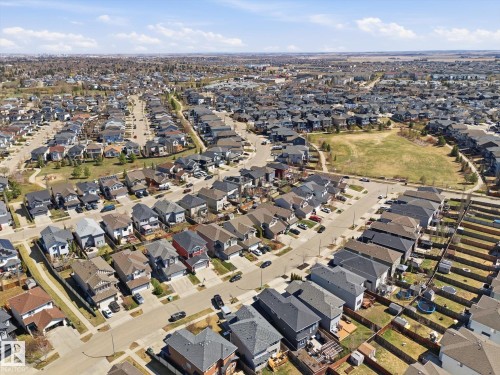 Aerial perspective showcasing a residential neighborhood with varied architectural styles and a central green space - 54 Cypress Link, Fort Saskatchewan, AB - Outdoor With View