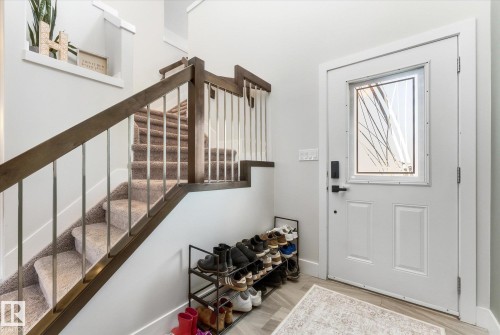 Entryway featuring a white paneled door with decorative glass insert - 54 Cypress Link, Fort Saskatchewan, AB - Indoor Photo Showing Other Room