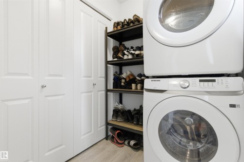 Stackable washer and dryer unit with a visible control panel - 9 850 Secord Boulevard, Edmonton, AB - Indoor Photo Showing Laundry Room