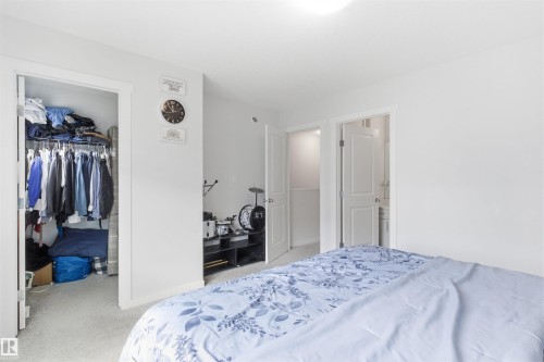 Bedroom featuring light-toned carpeting and white walls - 9 850 Secord Boulevard, Edmonton, AB - Indoor Photo Showing Bedroom