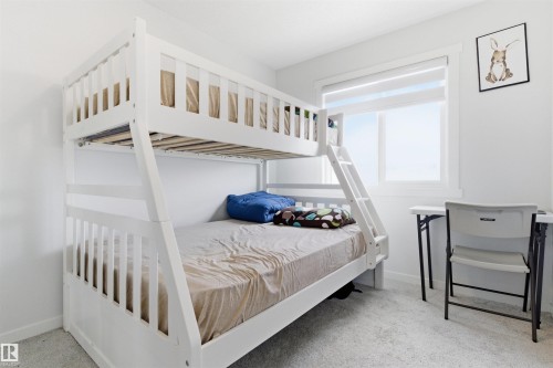 Bright room featuring light gray carpeting and white walls - 9 850 Secord Boulevard, Edmonton, AB - Indoor Photo Showing Bedroom