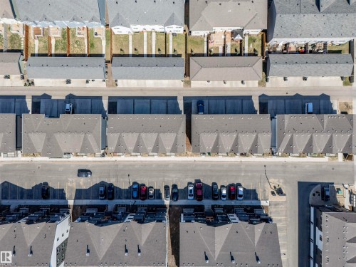 Aerial perspective showcasing multiple residential structures with gray shingle roofing - 9 850 Secord Boulevard, Edmonton, AB - Other