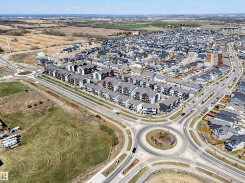 Aerial perspective showcasing an expansive residential area with numerous single-family homes and townhouses - 9 850 Secord Boulevard, Edmonton, AB - Outdoor With View