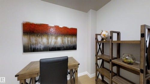 Dedicated workspace featuring light-toned walls and wood-finish flooring - #1603 10410 102 Av Nw, Edmonton, AB - Indoor