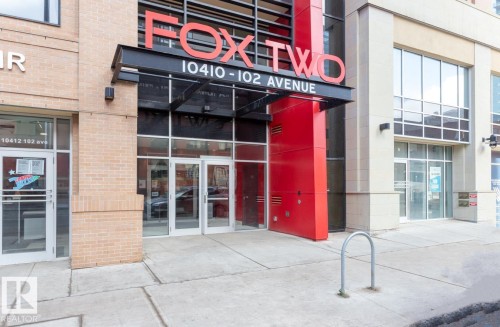 Modern building facade featuring a striking red architectural accent - #1603 10410 102 Av Nw, Edmonton, AB - Outdoor