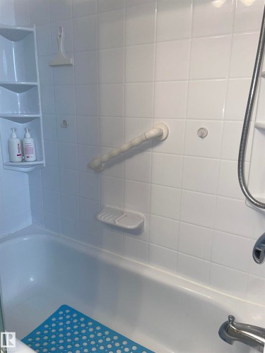 Bathroom featuring a white tiled shower and a bathtub - 14212 30 Street, Edmonton, AB - Indoor Photo Showing Bathroom