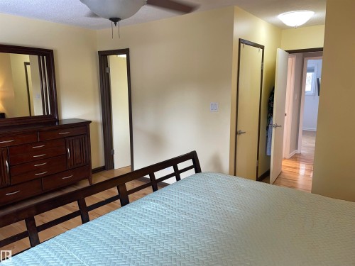 This room features light hardwood flooring and neutral-toned walls - 14212 30 Street, Edmonton, AB - Indoor Photo Showing Bedroom