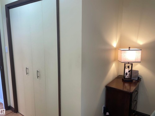 The property features a closet with bi-fold doors and dark trim - 14212 30 Street, Edmonton, AB - Indoor Photo Showing Other Room
