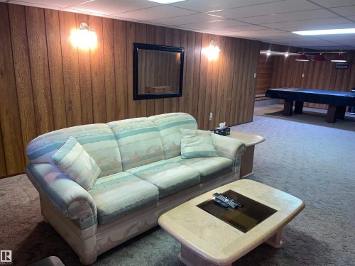 Recreation room featuring wood paneling, wall sconces, and carpeted flooring - 14212 30 Street, Edmonton, AB - Indoor Photo Showing Other Room