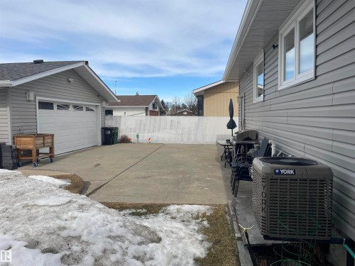 The property includes a detached garage with an automatic door and a paved driveway - 14212 30 Street, Edmonton, AB - Outdoor With Exterior