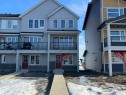 View of front facade featuring board and batten siding, brick siding, a shingled roof, and a balcony - 17237 4 Street, Edmonton, AB  - Outdoor With Balcony With Facade 
