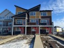View of front facade featuring board and batten siding, brick siding, a shingled roof, and a balcony - 17233 4 Street, Edmonton, AB  - Outdoor With Facade 