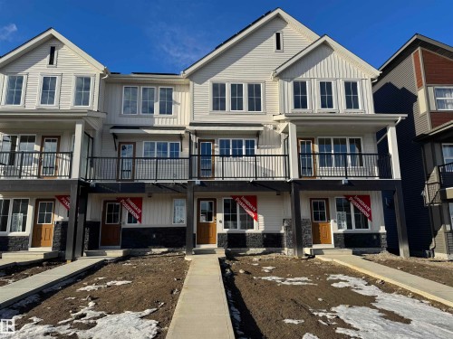 View of front facade featuring board and batten siding, brick siding, a shingled roof, and a balcony - 17236 4 Street, Edmonton, AB - Outdoor With Balcony With Facade