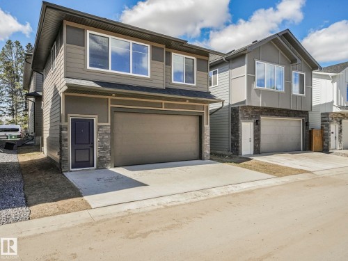 Contemporary two-story exterior featuring a two-tone facade with dark siding and lighter accents - 6125 Crawford Drive, Edmonton, AB - Outdoor