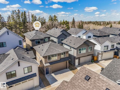 Modern residential architecture featuring a light brown exterior and dark shingle roof - 6125 Crawford Drive, Edmonton, AB - Outdoor