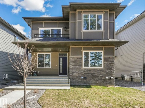 Contemporary two-story exterior featuring a prominent covered entry - 6125 Crawford Drive, Edmonton, AB - Outdoor With Exterior
