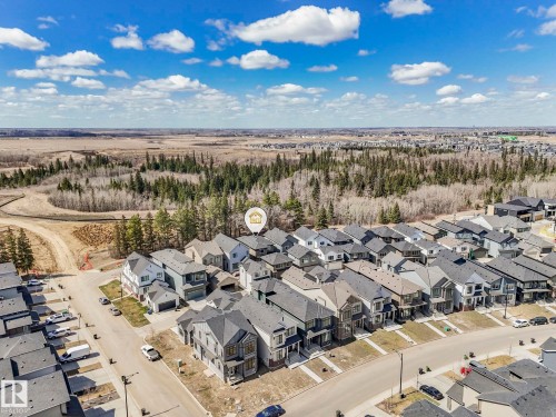 Aerial perspective showcasing a residential development bordered by natural wooded areas - 6125 Crawford Drive, Edmonton, AB - Outdoor With View