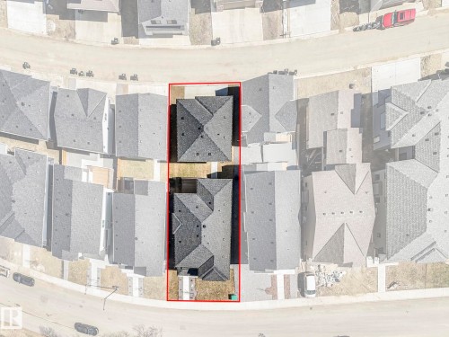 Property outlined in red, featuring two distinct structures with gabled roofs and dark shingles - 6125 Crawford Drive, Edmonton, AB - Other