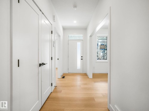 Hallway with wood-finish flooring, white walls, and recessed lighting - 6125 Crawford Drive, Edmonton, AB - Indoor Photo Showing Other Room