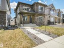 Contemporary two-story exterior featuring a covered front porch with stone pillar accents - 6125 Crawford Drive, Edmonton, AB  - Outdoor With Facade 
