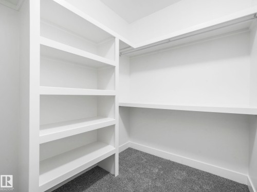 Built-in white shelving unit with multiple shelves - 6125 Crawford Drive, Edmonton, AB - Indoor Photo Showing Other Room