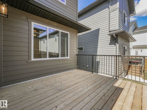 Exterior deck featuring wood flooring and black metal railings - 6125 Crawford Drive, Edmonton, AB - Outdoor With Deck Patio Veranda With Exterior