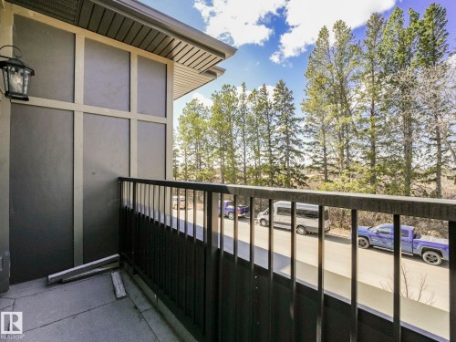 Balcony with dark metal railing and concrete flooring - 6125 Crawford Drive, Edmonton, AB - Outdoor With Exterior