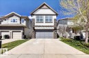 Modern architectural facade featuring horizontal siding, stone accents, and a prominent gable - 3936 Claxton Loop, Edmonton, AB  - Outdoor With Facade 