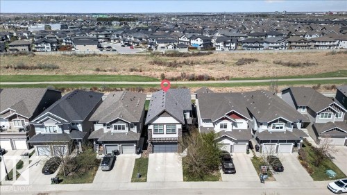 Two-story residential architecture with a gabled roofline and attached front-facing garage - 3936 Claxton Loop, Edmonton, AB - Outdoor