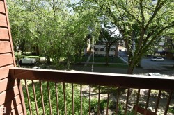 Balcony featuring a metal railing and a partial brick exterior - 