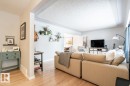 Open-concept living space featuring wood-finish flooring, white baseboards, and a neutral wall palette - 8239 93A Avenue, Edmonton, AB  - Indoor Photo Showing Living Room 