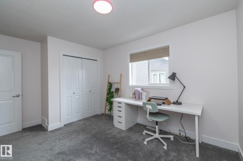 This room features neutral-toned walls, a window with a blind, and grey carpet - 14 Edgewater Terr North, St. Albert, AB - Indoor Photo Showing Office