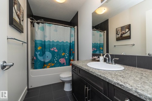 Bathroom featuring a vanity with a light-colored countertop, a white oval sink, and a large mirror - 14 Edgewater Terr North, St. Albert, AB - Indoor Photo Showing Bathroom