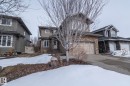 The property features a two-story home with a stone and siding exterior, an attached garage, and a paved driveway - 14 Edgewater Terr North, St. Albert, AB  - Outdoor With Facade 